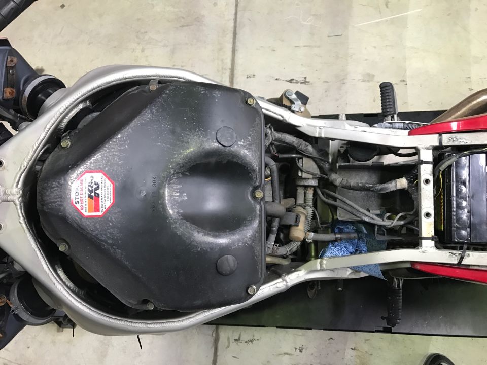 Top-down view of black fuel tank and frame on motorcycle chassis