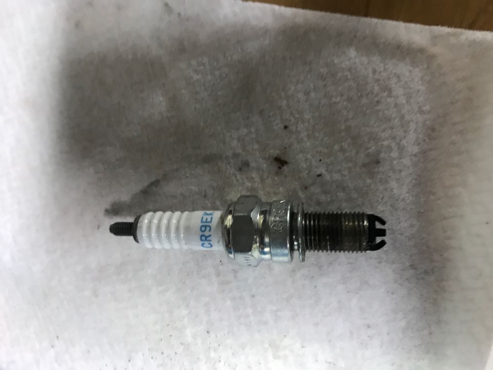 Spark plug with CR9EK marking on white paper towel