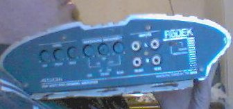 1986 Ford Taurus - A blue car amplifier with various controls and input jacks is shown.