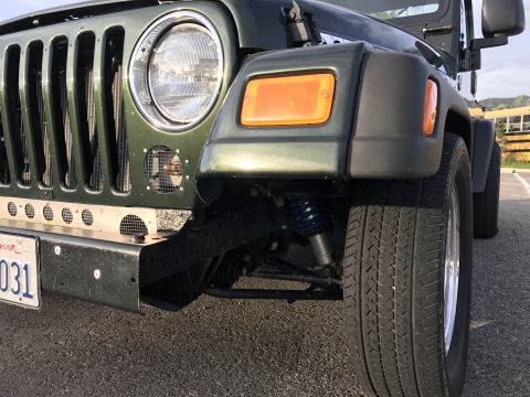 1968 Ford Mustang - Photograph of a Jeep Wrangler front corner showing headlight and suspension, not a technical document.