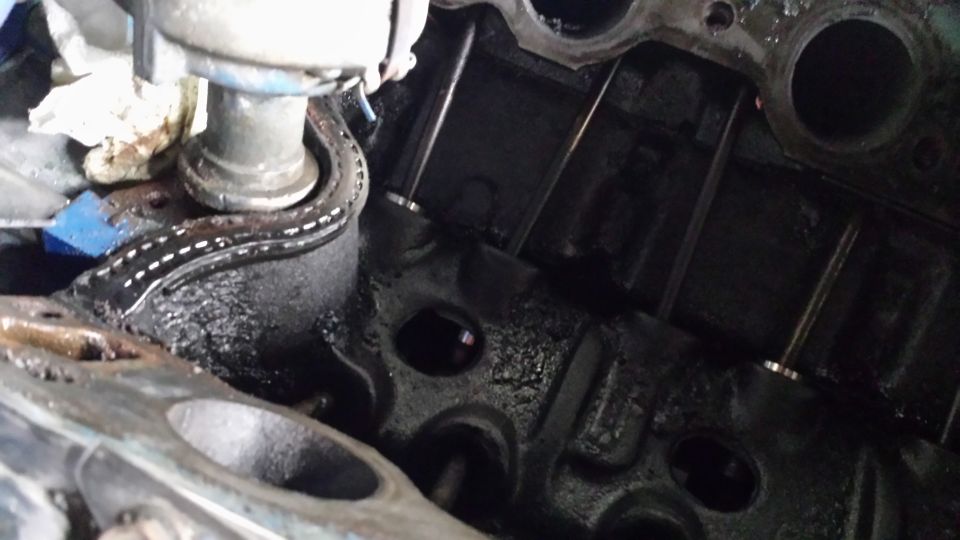 Internal view of a V8 engine with cylinder heads, valves, and pushrods visible.