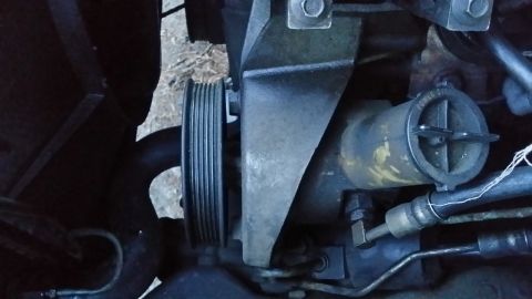 1996 Ford F-250 - Off comes the pulley, you do need a special tool for this. Behind the pulley are 3 17mm bolts (11/16 will work in a pinch) that need to com…