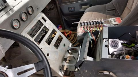 1990 Ford Bronco - Photo of a truck dashboard removed showing exposed wiring and switches, not a technical document.