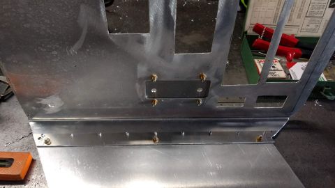 1990 Ford Bronco - Photo of an aluminum dash panel with a riveted bracket, not a technical document.
