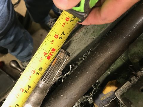 1996 Ford Bronco - A measuring tape is used to inspect the suspension of a vehicle.