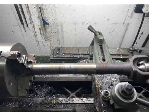 1996 Ford Bronco - Machining a metal shaft on a lathe in a workshop environment.
