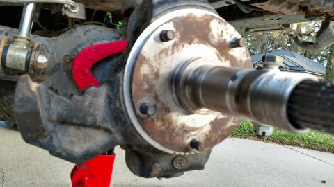 1992 Ford Bronco - Close-up view of a vehicle's front axle and hub assembly, a red accent piece.