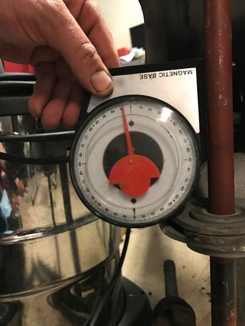 1996 Ford Bronco - A magnetic base protractor tool is used to measure an angle on a metal component.