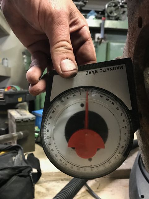 1996 Ford Bronco - A magnetic base protractor tool is used to measure an angle on a metal component.