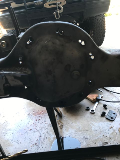 1996 Ford Bronco - Close-up of a Ford Bronco rear axle differential housing, likely from a 1996 model, with tools nearby.