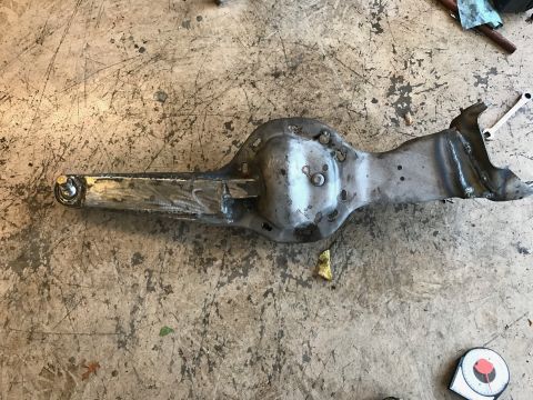 1996 Ford Bronco - This is a cut and turned axle housing, likely for off-road modification, resting on a workshop floor.
