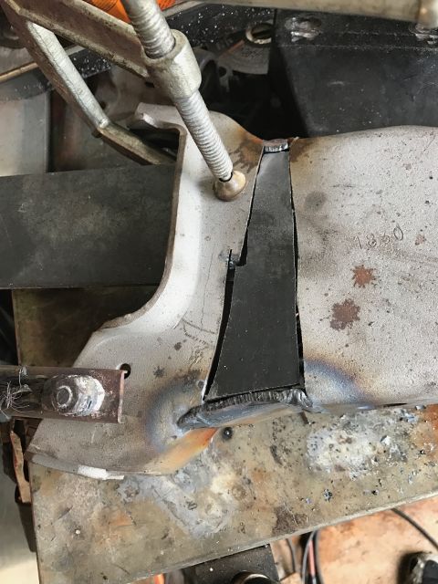 1996 Ford Bronco - A close-up view shows a metal bracket that has been cut and welded. A clamp is holding the bracket in place, with visible weld marks and so…