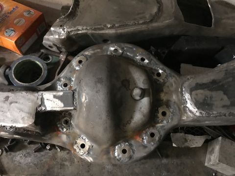 1996 Ford Bronco - A close-up view of a differential housing that has been welded and drilled. Several holes are visible around the housing, along with eviden…