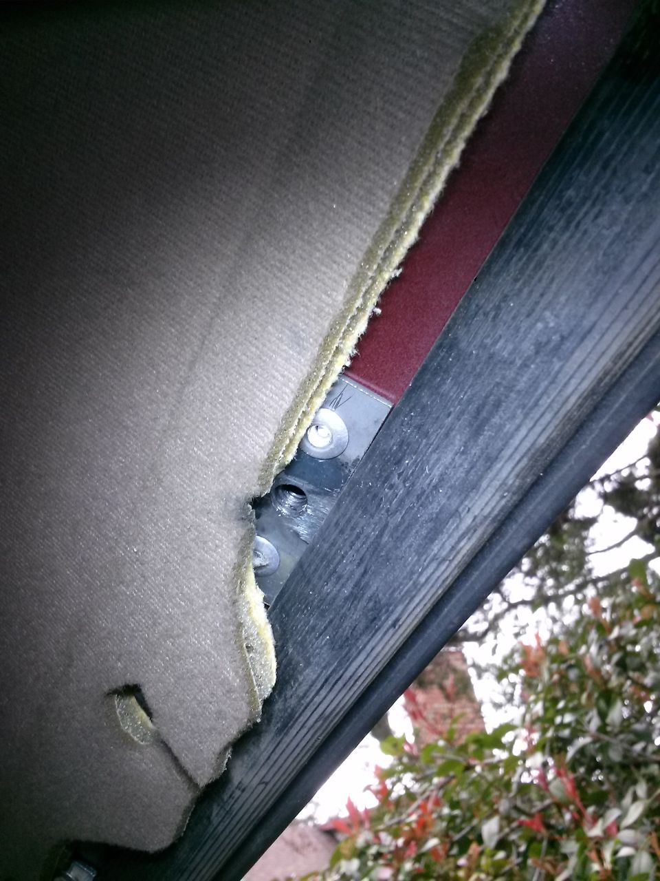 Interior headliner of a 1996 Ford Bronco with exposed mounting hardware.