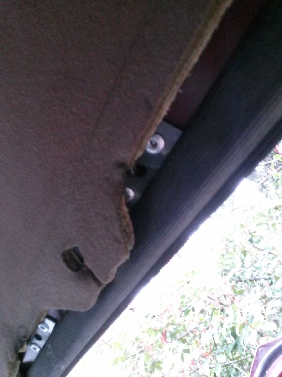 Interior headliner with visible mounting bracket and screws.