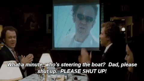 1995 Mercury Grand Marquis - A scene from the movie Step Brothers showing men seated at a restaurant table with a projected image of a person in sunglasses behind them,…