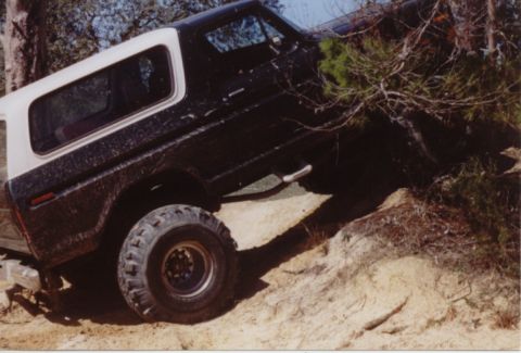 1995 Ford Bronco - This 1978 Ford Bronco is shown navigating a steep, sandy incline, with its front-right tire angled upwards.