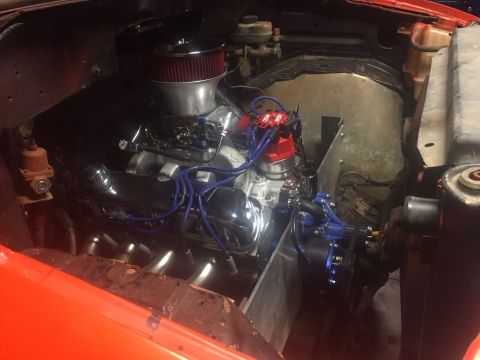 1982 Ford Bronco - A close-up view of a custom V8 engine installed in an engine bay. The engine features chrome valve covers, a chrome air cleaner, and bright…