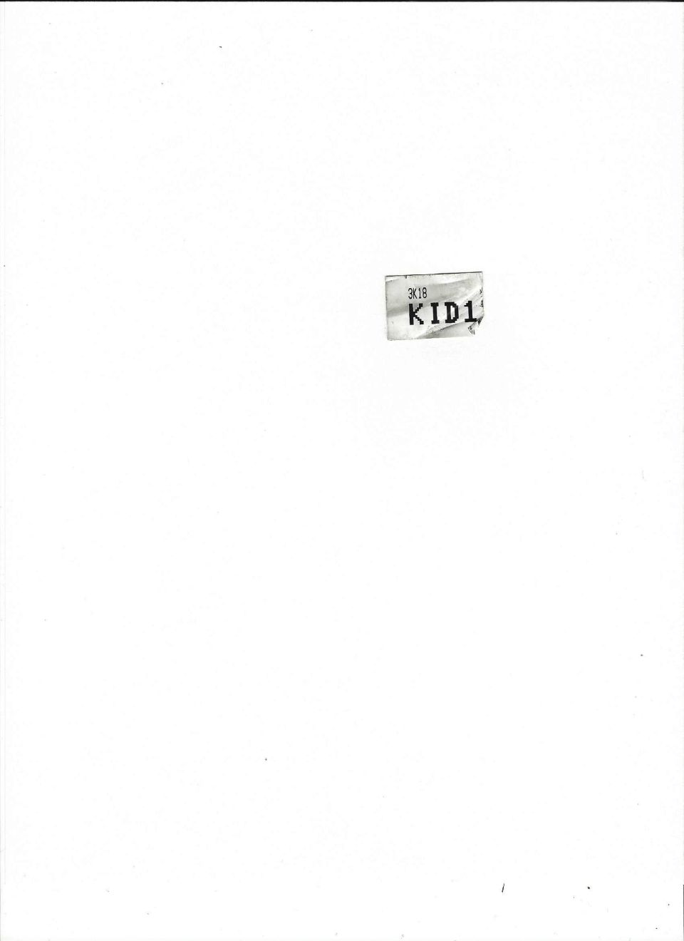 A piece of paper with text '3K18 KID1' on a white background.