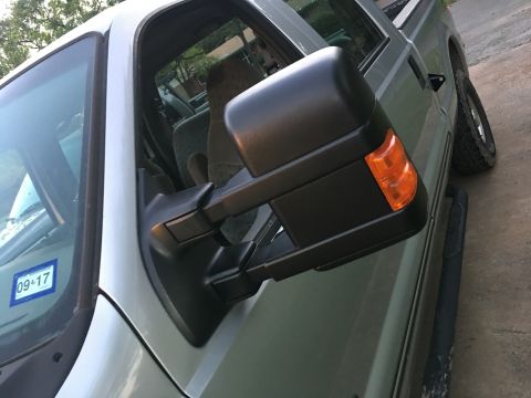 2004 Ford F-150 - Close-up view of a truck's side mirror and door panel, showing a registration sticker on the windshield.