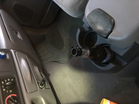 2004 Ford F-150 - A bottle rests in the cup holder of a 2004 Ford F-150's interior.
