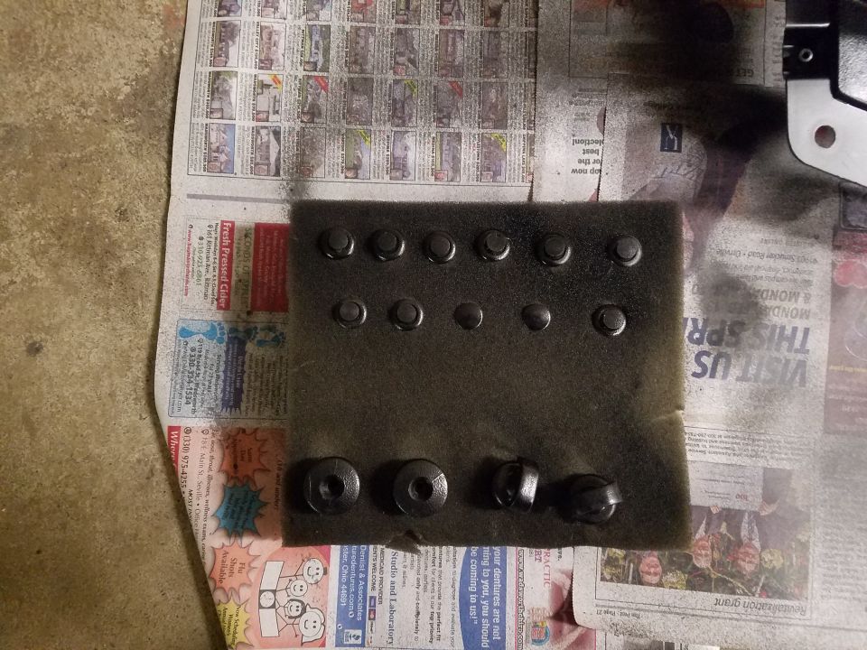 bolts and washers laid out on newspaper, some painted black