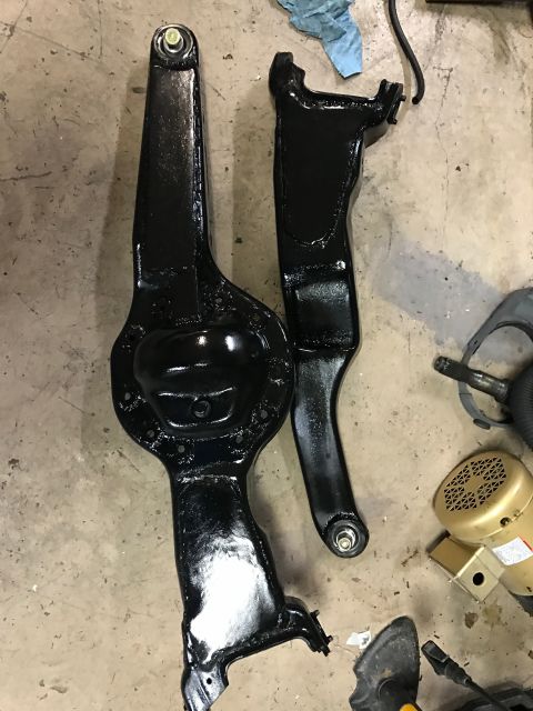 1996 Ford Bronco - Black painted suspension parts, possibly from a Ford Bronco, are laid out on a concrete surface.