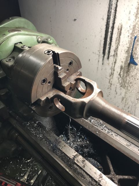 1996 Ford Bronco - A metal component is held in a lathe chuck, undergoing machining operations.