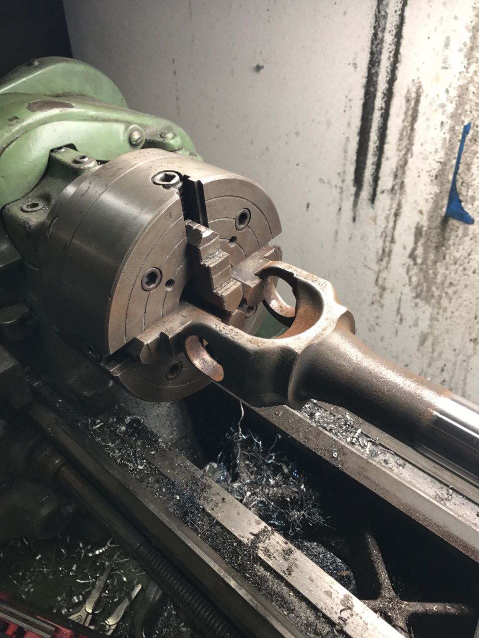Metal part being machined on a lathe