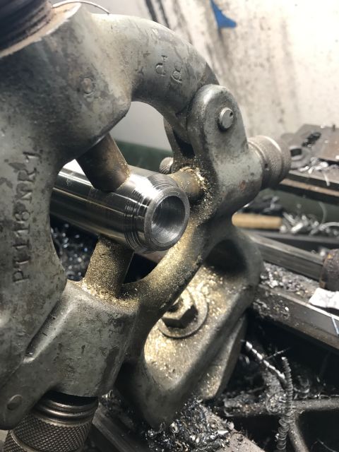 1996 Ford Bronco - Metal part being precisely machined on a lathe, creating metal shavings.