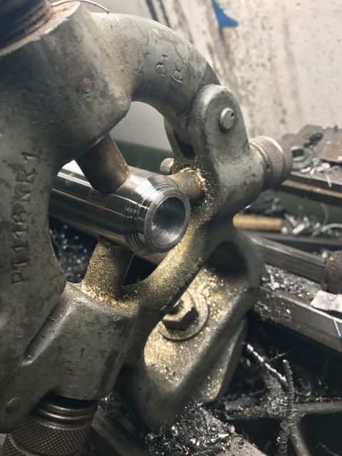 1996 Ford Bronco - A metal rod is being precisely shaped by a lathe in a workshop setting.