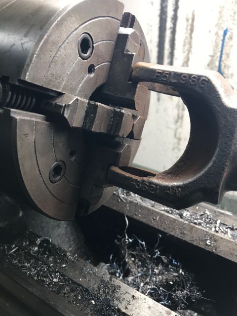 1996 Ford Bronco - A metal component, marked F5L986, is being machined on a lathe.