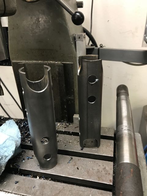 1996 Ford Bronco - Metal parts are being machined on a milling machine, with metal shavings visible on the surface.