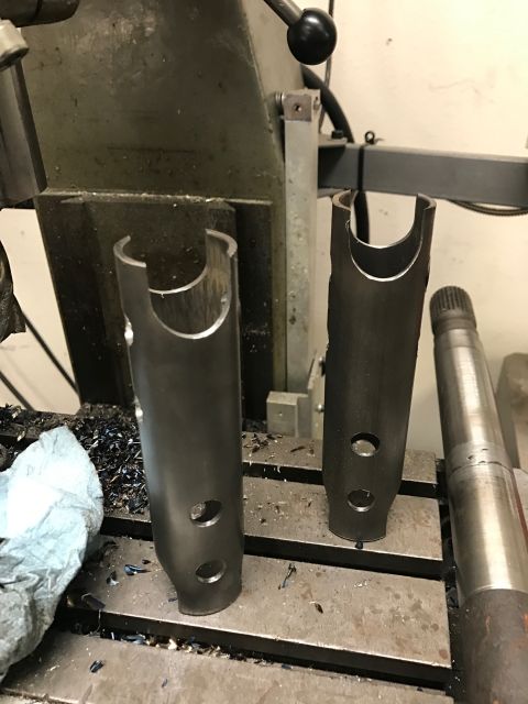 1996 Ford Bronco - Machined parts and a splined shaft sit on a milling machine table with metal shavings around them.