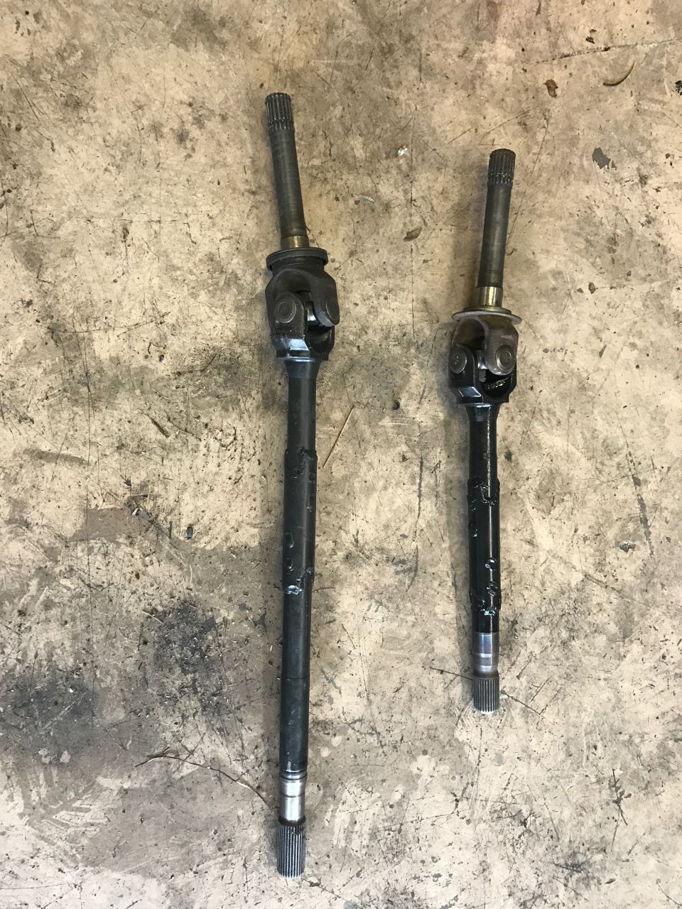 Two drive axles with U-joints, one longer than the other