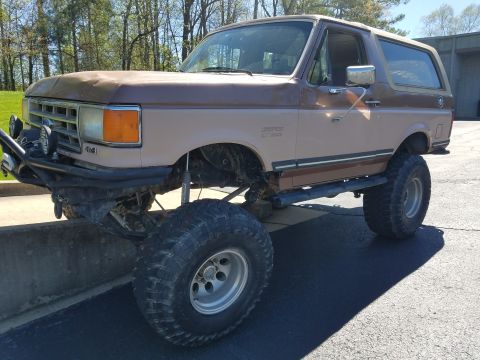 1988 Ford Bronco - This modified 1988 Ford Bronco features a significant lift kit and aggressive tires for off-road use.