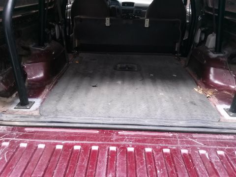 1996 Ford Bronco - Interior view of the cargo area in a 1996 Ford Bronco, showing the floor and rear seating.