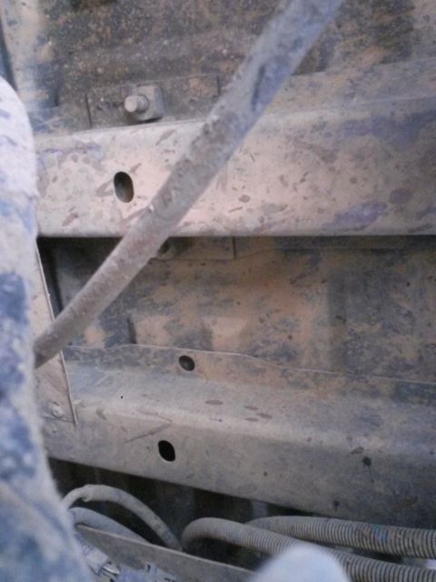 1996 Ford Bronco - Undercarriage view shows metal frame components and wiring harnesses.