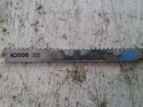 1996 Ford Bronco - A Bosch jigsaw blade, marked 'SWISS MADE', is shown against a textured surface.