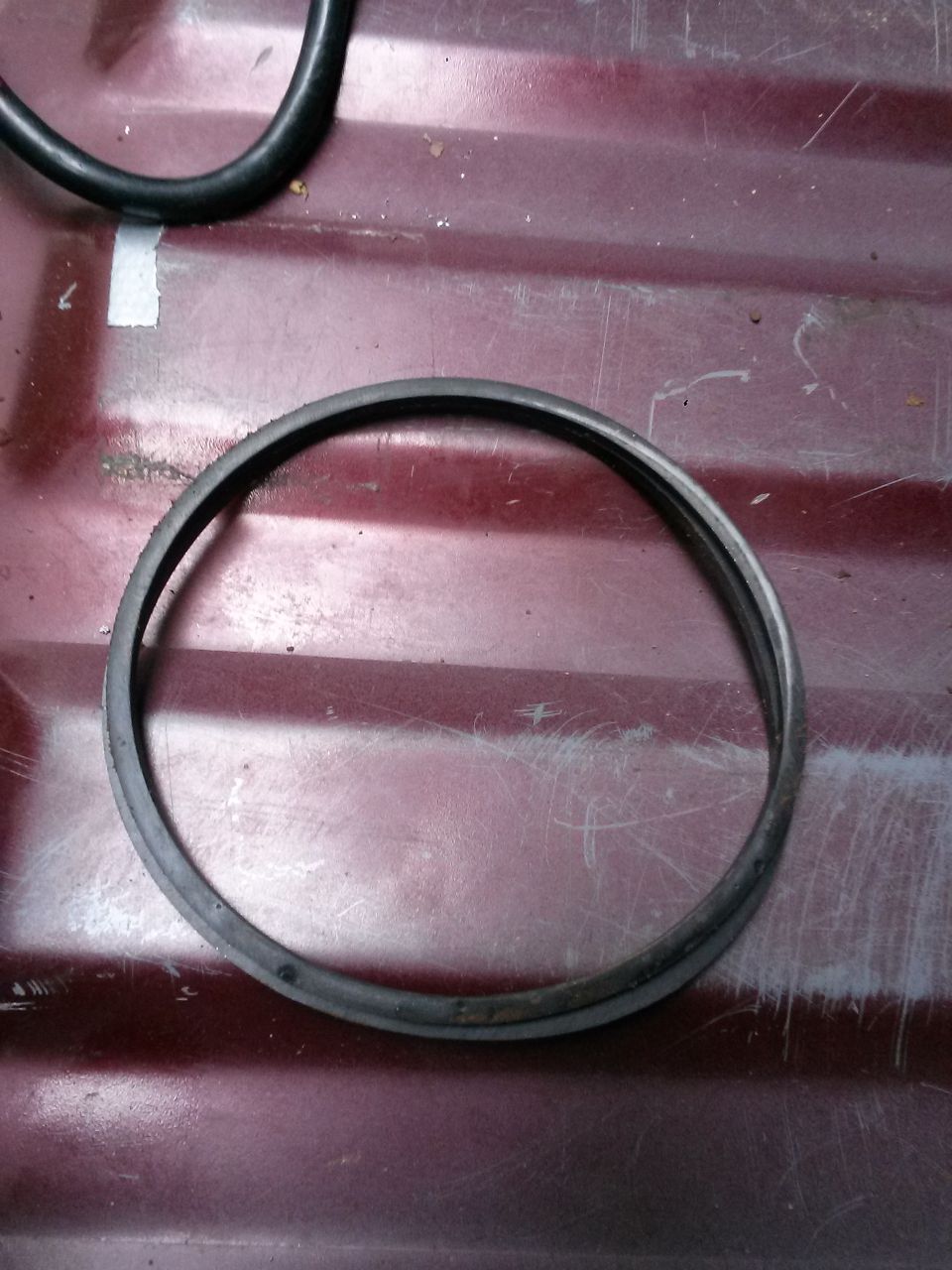 Fuel float seal ring on a red surface