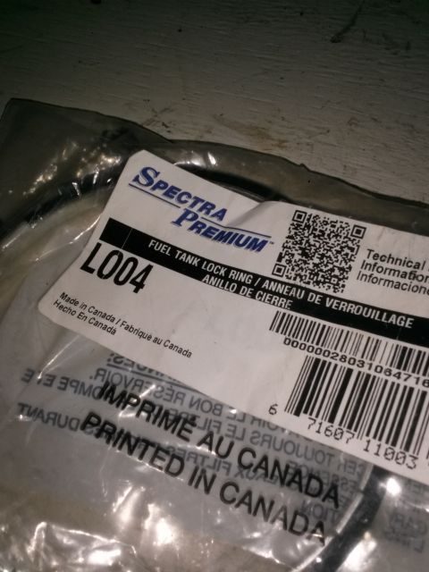 1996 Ford Bronco - Spectra Premium fuel tank lock ring part, labeled L004 and made in Canada.