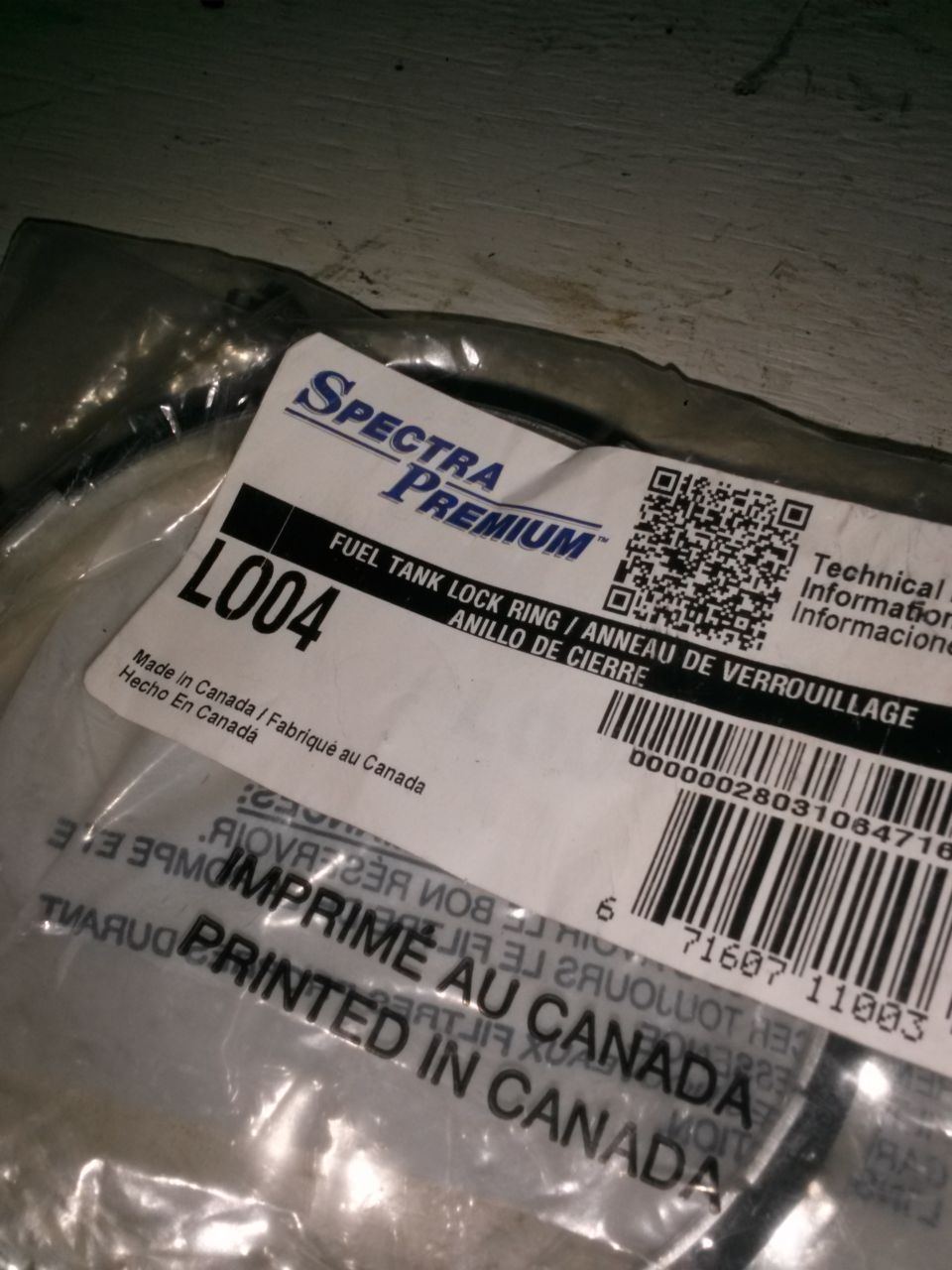 Fuel tank lock ring part in plastic packaging with Spectra Premium label
