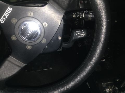 2015 Subaru Impreza - Interior view showing an aftermarket steering wheel and cruise control stalk with visible labels.