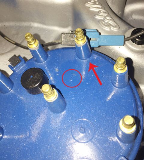 1978 Ford Bronco - A close-up view of a vehicle's distributor cap, showing a small 'T' marking.