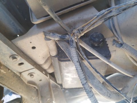 1988 Ford Bronco - Underside view of a vehicle's fuel system components and wiring harnesses.