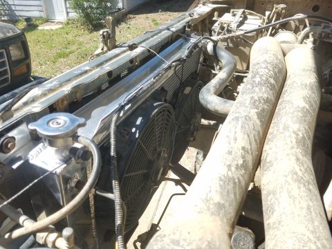 1988 Ford Bronco - Close-up view of the engine bay, focusing on the radiator and cooling fans.