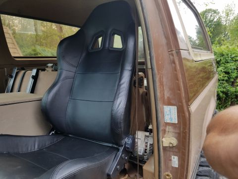 1988 Ford Bronco - Interior view of a 1988 Ford Bronco, a new black racing seat installed.