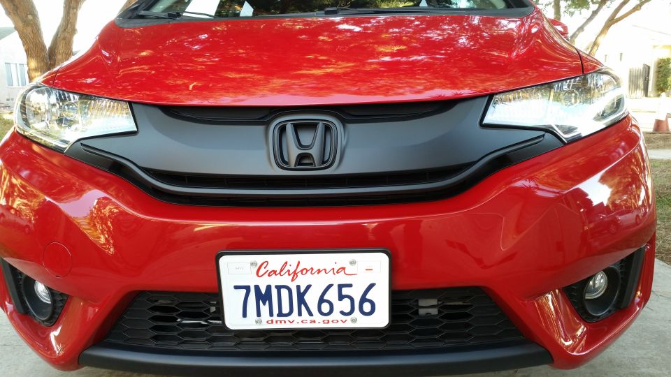 Front view of a red 2015 Honda Fit with a California license plate