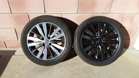 2015 Honda Fit - Two car wheels and tires are shown side-by-side against a brick wall.