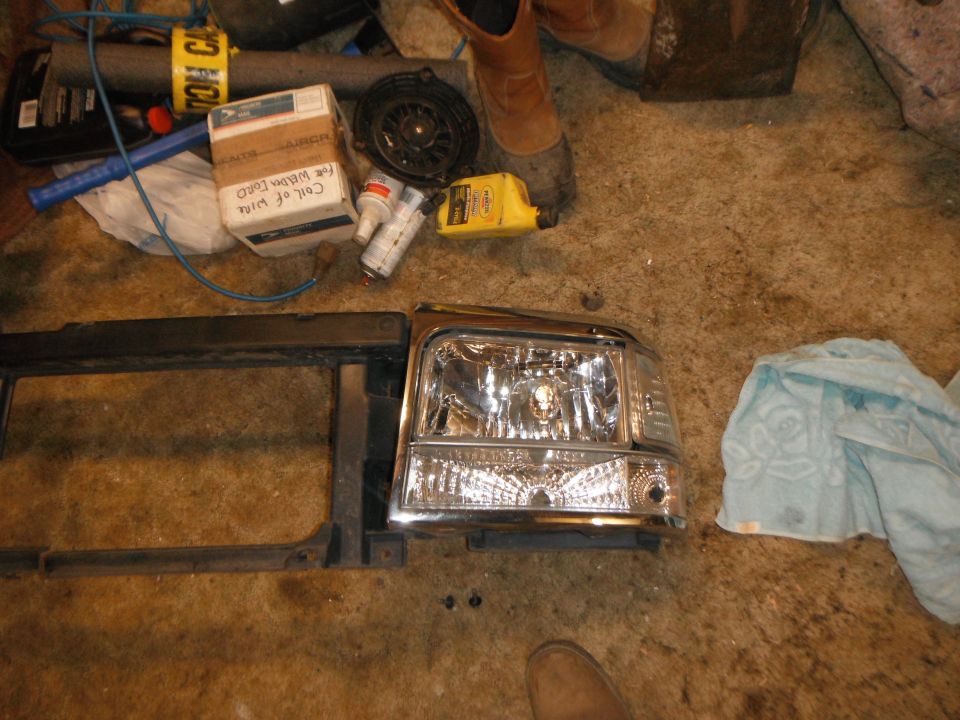 Chrome headlight and black grille assembly on floor